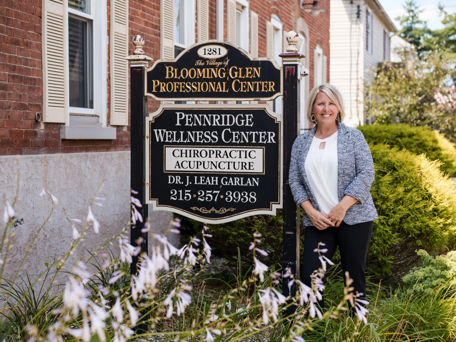 Dr. J. Leah Garlan outside the Pennridge Wellness Center sign in Perkasie